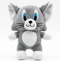 A plush toy of Tom and Jerry's classic gray cat character, featuring blue eyes, a white chest, and white paws, set against a plain white background.