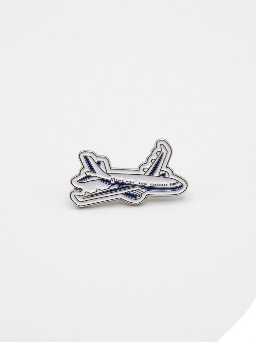 Airplane-shaped enamel pin on a white background QATAR PRICE