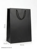 Black paper bag with dimensions indicated on a white background QATAR  PRICE