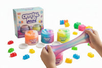 Child playing with colorful Crystal Mud slime on a table with packaging in the background. QATAR PRICE