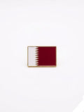 Flag pin of Qatar on a white background