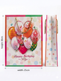 Greeting card with colorful balloons and 'Happy Birthday' text, accompanied by a matching gift bag. QATAR PRICE