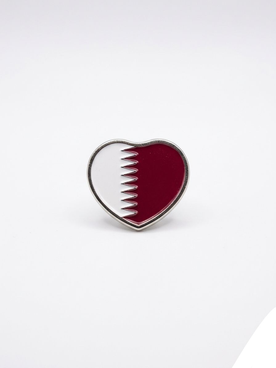 Heart-shaped pin with Qatar flag design on a white background QATAR PRICE