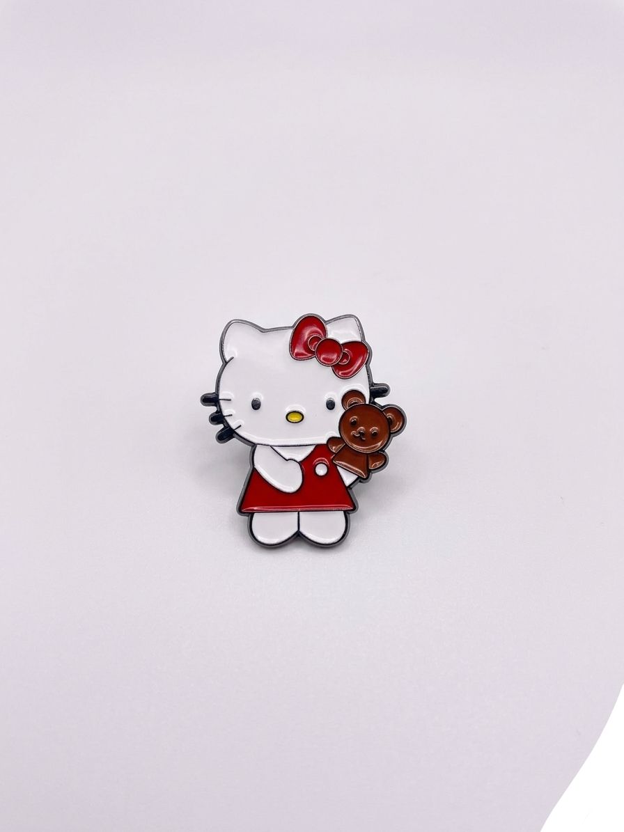 Hello Kitty pin with a teddy bear on a white background QATAR PRICE