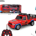 Red toy truck with Spider-Man design, remote control, and packaging in the background QATAR PRICE