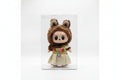 Toy figure with a hat and coat next to its packaging on a white background QATAR PRICE
