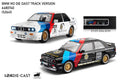 Two model cars, a white and red one, and a black and blue one, with branding and specifications displayed.QATAR