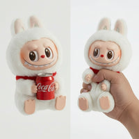 Plush toy with a Coca-Cola can held by a hand on a white background